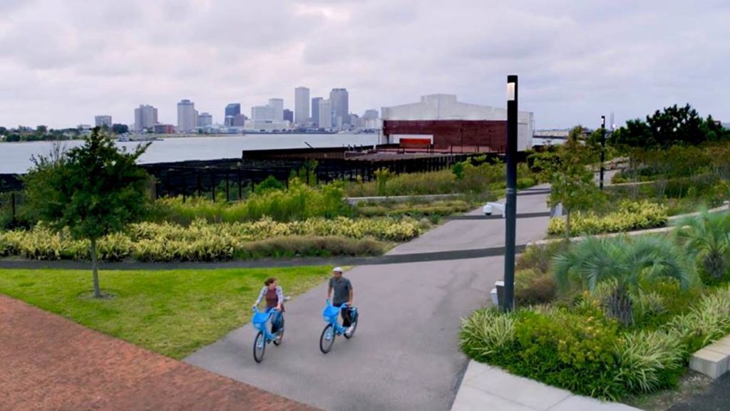 This is a photograph of two people riding Blue Bikes in New Orleans.