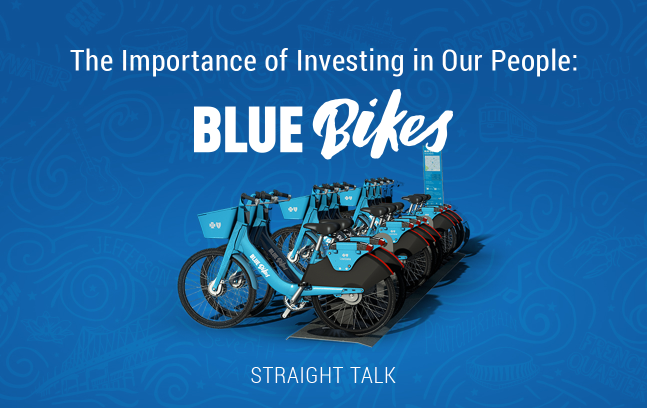 This is an image with a row of blue bikes with text that reads: "The Importance of Investing in Our People: Blue Bikes."