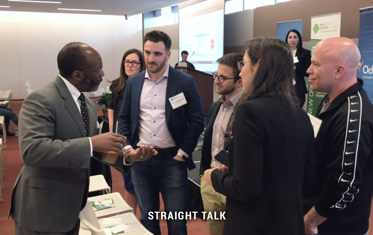 This is a photo of a group of people talking with text that reads "Straight Talk."